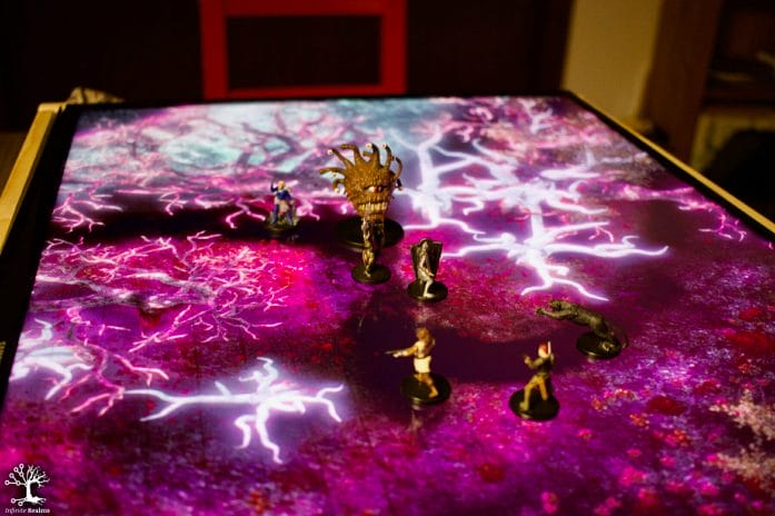 Infinite Realms: Real minis standing on digital map