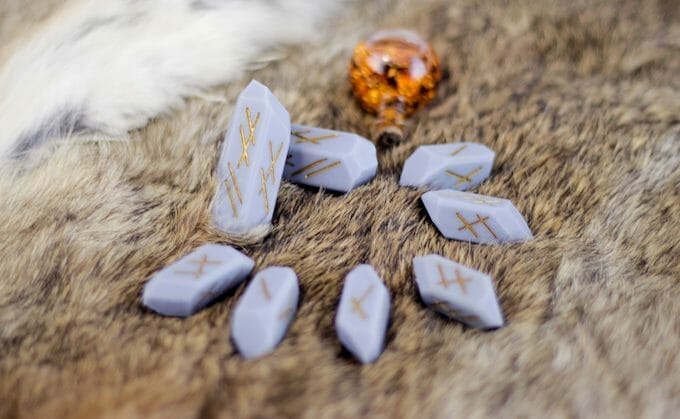 Eternalverse rune dice on a fur skin rug