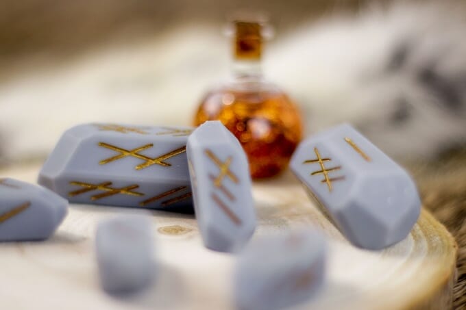 Eternalverse runic dice by an out of focus potion bottle