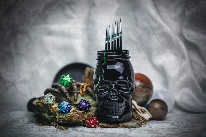 Black skull brush pot with dice and decorations