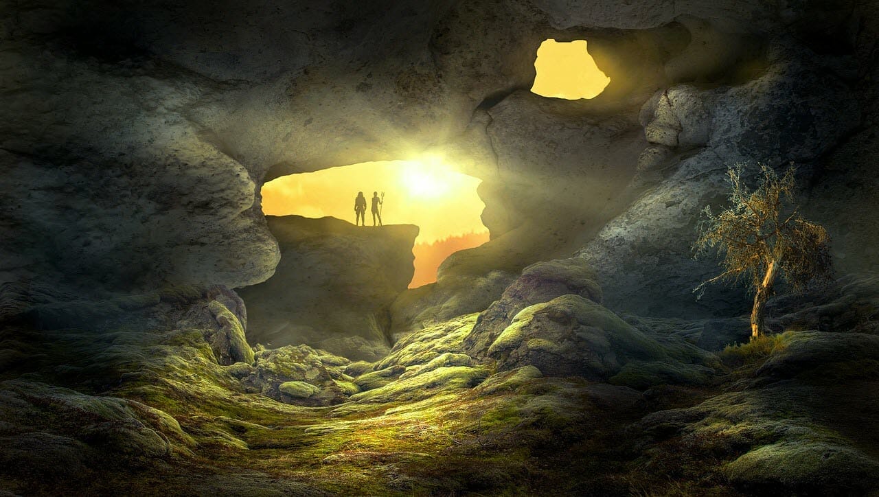 Figures standing in entrance to cave