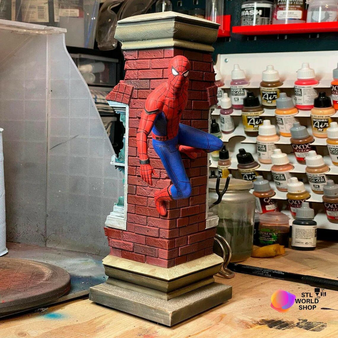 Spider-man hanging to red brick corner