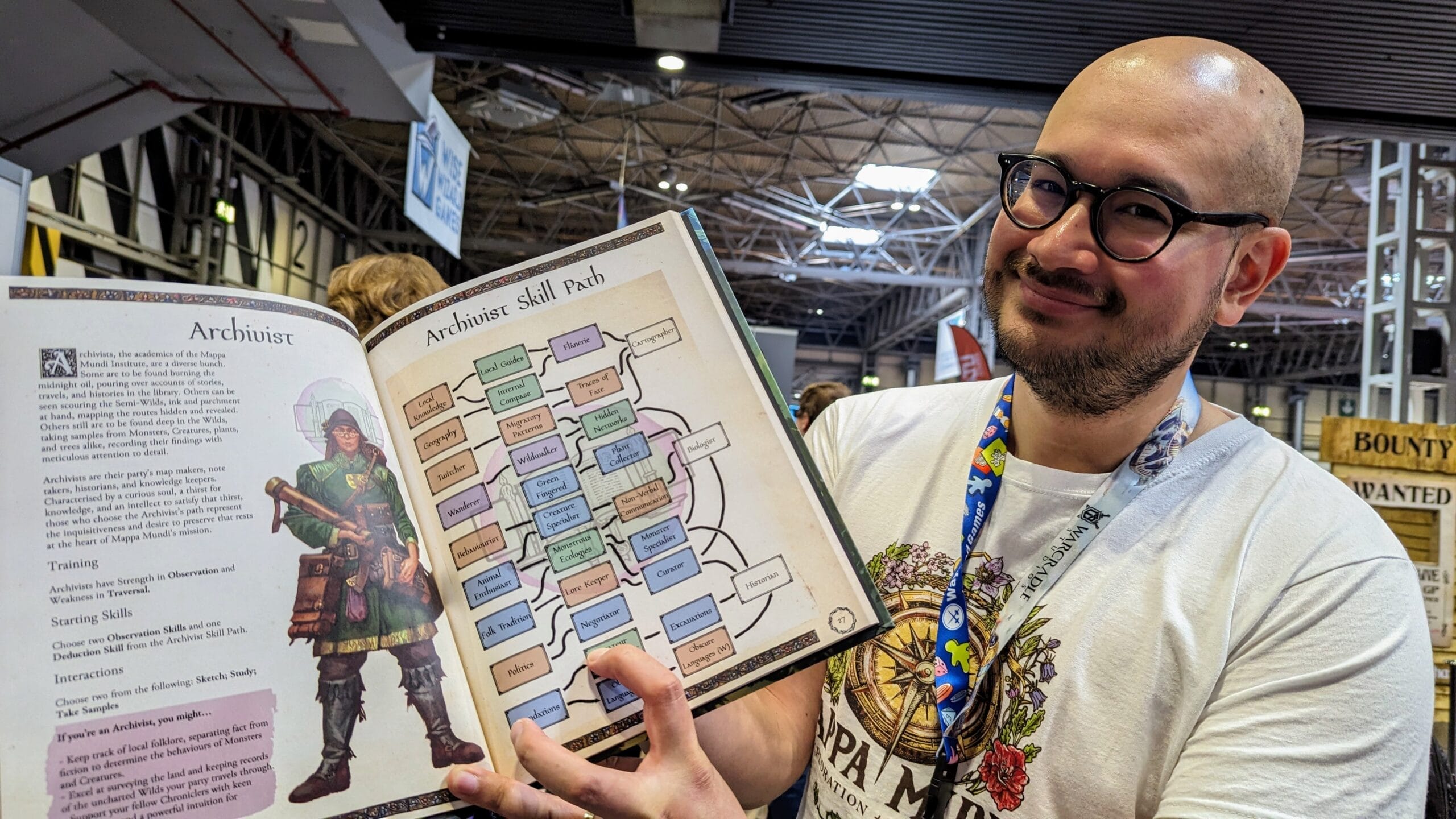 AUthor holds book open to show skill trees and a character type